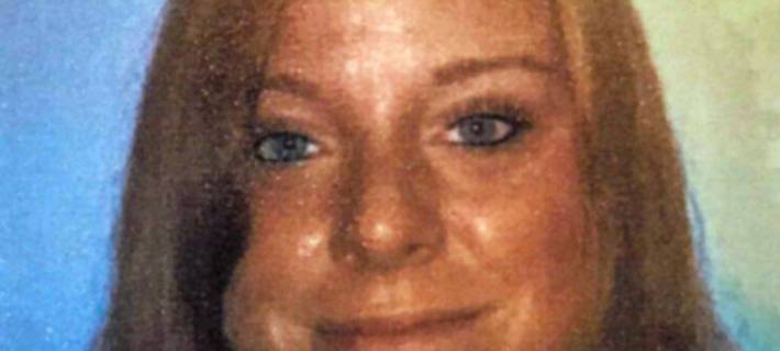 Junge Frau mit braunen Haaren lächelt in die Kamera