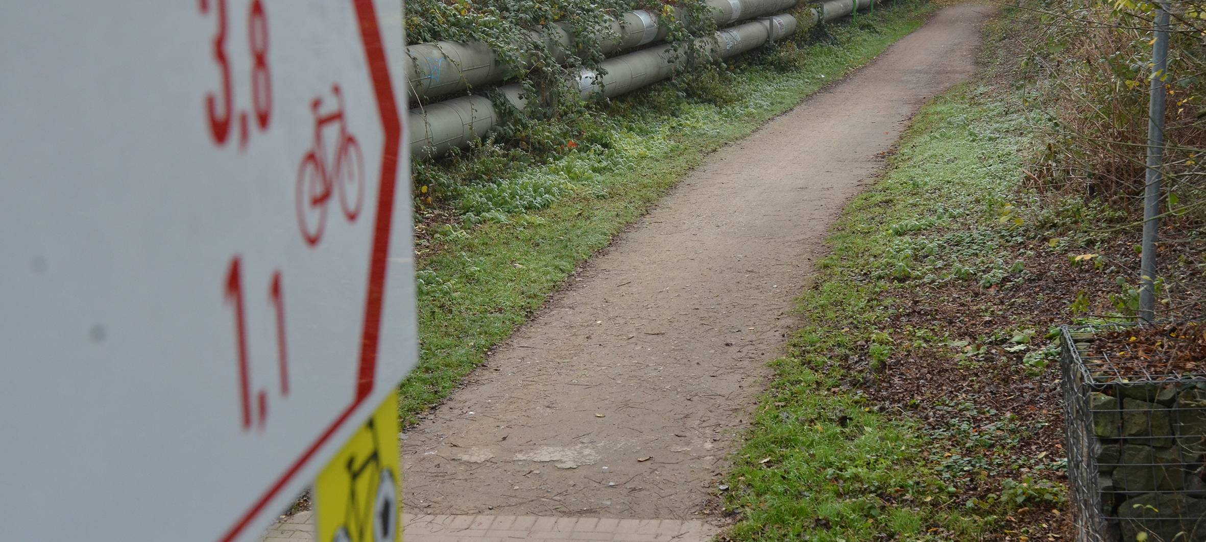 Das Bild zeigt eins der neuen Schilder und einen Teil des Radwegs