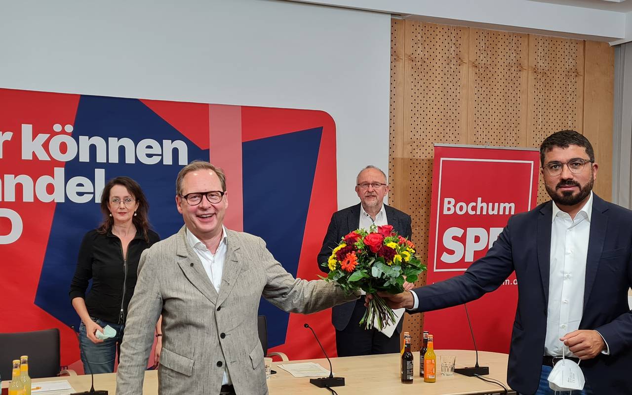 Der bisherige SPD-Vorsitzende Bochum übergibt Blumen an seinen Nachfolger 